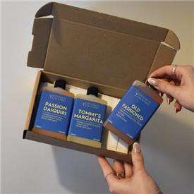 Gifting selection box of bottled cocktails with blue labels.
